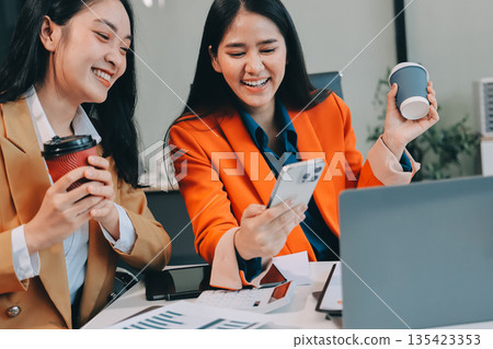Businesswomen having discussion in office Businesswomen having discussion in office 135423353