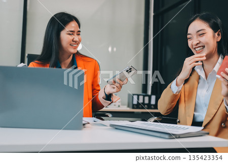 Businesswomen having discussion in office Businesswomen having discussion in office 135423354