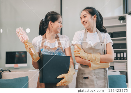 Cleaners clean empty office spaces Cleaners clean empty office spaces 135423375