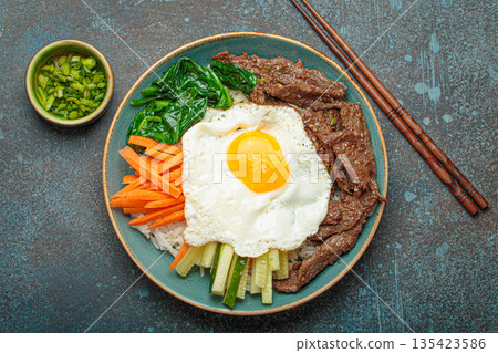 Traditional korean dish bibimbap with fried egg on top, top view 135423586