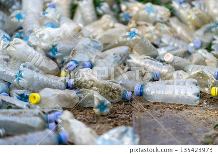 View of many used dirty plastic bottles on the ground. View of many used dirty plastic bottles on the ground. 135423973