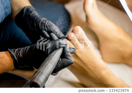View of the process of a pedicure performed by a master. 135423974