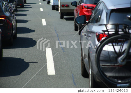 Heavy traffic congestion on highway with cars, tunnels, and traffic signals. Heavy traffic congestion on highway with cars, tunnels, and traffic signals. 135424013