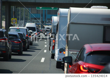 Heavy traffic congestion on highway with cars, tunnels, and traffic signals. Heavy traffic congestion on highway with cars, tunnels, and traffic signals. 135424014