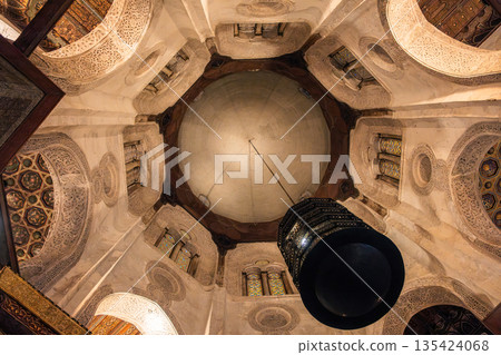 Interior view of the Qalawun Complex on Al-Muizz Street. Features intricate Islamic architecture, domed ceiling, and decorative elements. 135424068