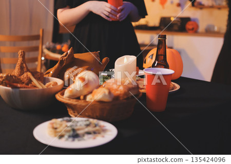 Friends enjoying a Halloween party at a bar making a toast Friends enjoying a Halloween party at a bar making a toast 135424096