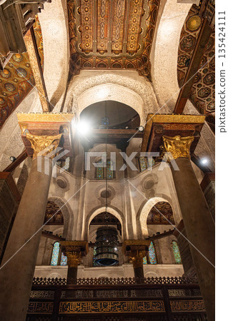 Interior view of the Qalawun Complex on Al-Muizz Street. Features intricate Islamic architecture with ornate ceilings and detailed wooden elements Interior view of the Qalawun Complex on Al-Muizz Street. Features intricate Islamic architecture with ornate ceilings and detailed wooden elements 135424111