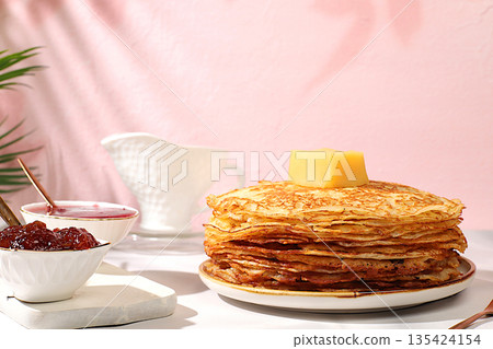 Maslenitsa concept. Delicious Russian pancakes with jam, soft cottage cheese, preserves, sour cream, and honey on a marble table. Healthy breakfast from natural ingredients, natural products Maslenitsa concept. Delicious Russian pancakes with jam, soft cottage cheese, preserves, sour cream, and honey on a marble table. Healthy breakfast from natural ingredients, natural products 135424154
