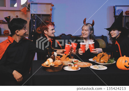 Friends enjoying a Halloween party at a bar making a toast Friends enjoying a Halloween party at a bar making a toast 135424213