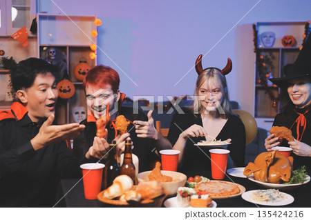 Friends enjoying a Halloween party at a bar making a toast Friends enjoying a Halloween party at a bar making a toast 135424216