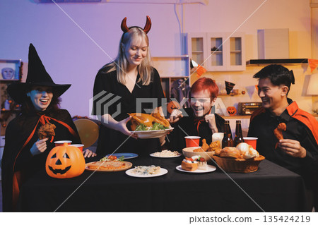 Friends enjoying a Halloween party at a bar making a toast Friends enjoying a Halloween party at a bar making a toast 135424219