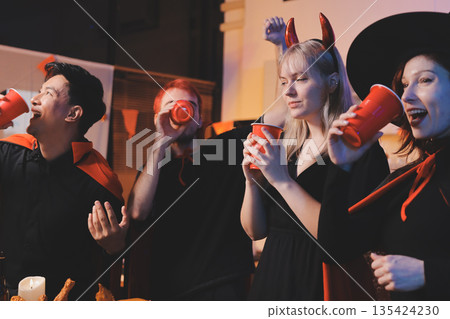 Friends enjoying a Halloween party at a bar making a toast Friends enjoying a Halloween party at a bar making a toast 135424230