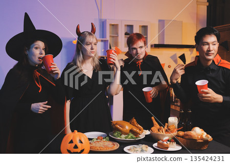 Friends enjoying a Halloween party at a bar making a toast 135424231