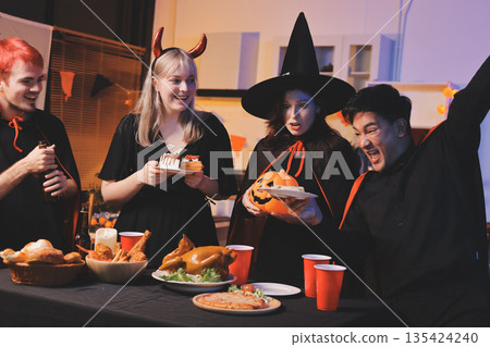 Friends enjoying a Halloween party at a bar making a toast Friends enjoying a Halloween party at a bar making a toast 135424240