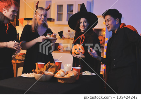 Friends enjoying a Halloween party at a bar making a toast Friends enjoying a Halloween party at a bar making a toast 135424242