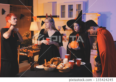 Friends enjoying a Halloween party at a bar making a toast Friends enjoying a Halloween party at a bar making a toast 135424245