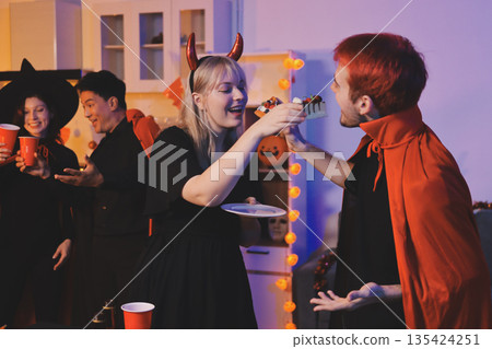 Friends enjoying a Halloween party at a bar making a toast Friends enjoying a Halloween party at a bar making a toast 135424251
