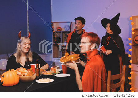 Friends enjoying a Halloween party at a bar making a toast Friends enjoying a Halloween party at a bar making a toast 135424256