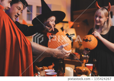 Friends enjoying a Halloween party at a bar making a toast Friends enjoying a Halloween party at a bar making a toast 135424267