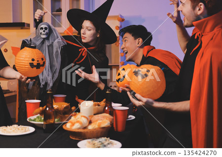 Friends enjoying a Halloween party at a bar making a toast Friends enjoying a Halloween party at a bar making a toast 135424270