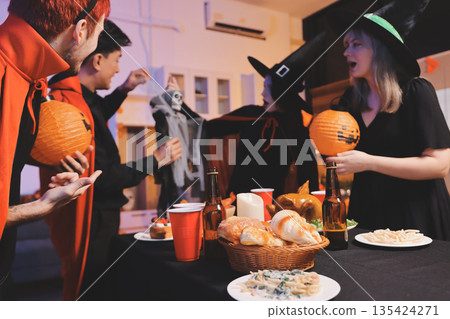 Friends enjoying a Halloween party at a bar making a toast Friends enjoying a Halloween party at a bar making a toast 135424271