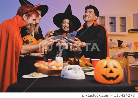 Friends enjoying a Halloween party at a bar making a toast Friends enjoying a Halloween party at a bar making a toast 135424278