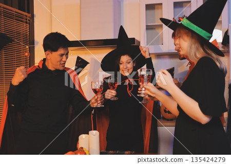 Friends enjoying a Halloween party at a bar making a toast Friends enjoying a Halloween party at a bar making a toast 135424279