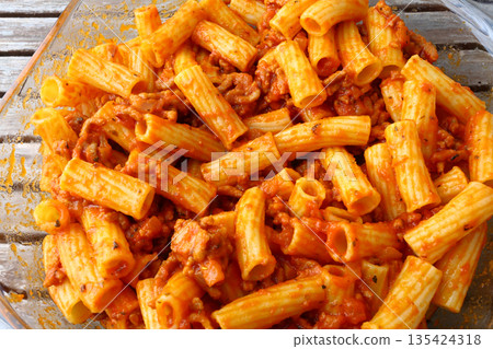 Classic macaroni bolognese with tomato meat sauce and grated cheese topping. Classic macaroni bolognese with tomato meat sauce and grated cheese topping. 135424318