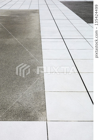 Concrete floor and white tiled pathway 135424499