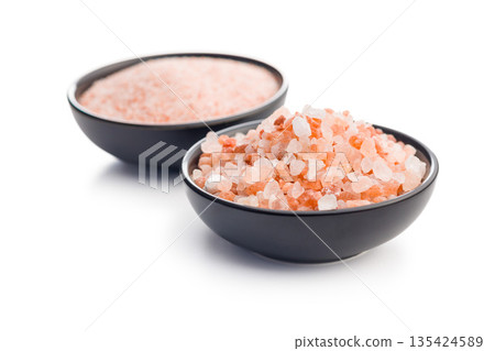 Pink Himalayan salt in bowl isolated on white background. Pink Himalayan salt in bowl isolated on white background. 135424589