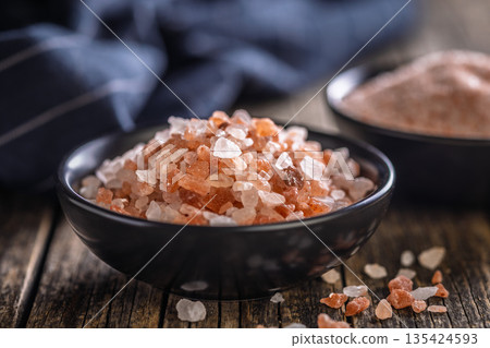 Pink Himalayan salt in bowl on wooden table. Pink Himalayan salt in bowl on wooden table. 135424593