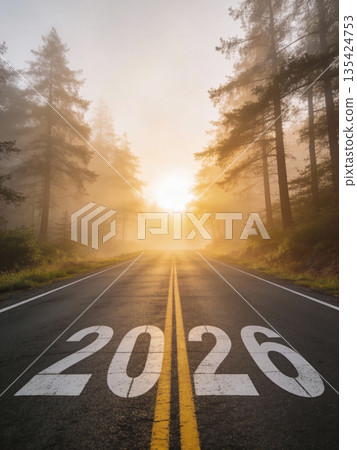 Looking ahead to 2026: A road to future vision. The image features the road towards 2026 with a beautiful sunset sky and mountains in background. 135424753