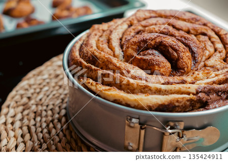 Giant cinnamon roll cake fresh from the oven 135424911
