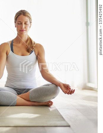 Calm woman, yoga and meditation on mat for spiritual wellness, zen or healthy workout on floor at home. Relaxed female person or yogi meditating for mindful exercise or awareness with mockup space 135425492