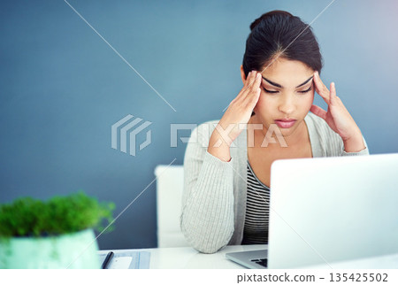 Business woman, headache and pain with laptop, office and hands for mistake, anxiety or stress at startup. Young businesswoman, burnout and pain with fatigue, frustrated and glitch on pc in workplace 135425502