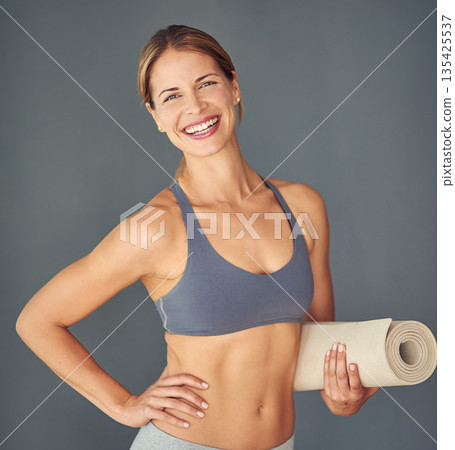 Happy woman, fitness and portrait for yoga exercise, zen workout or healthy body against a grey studio background. Female person or yogi with smile and mat for spiritual wellness and mental health 135425537