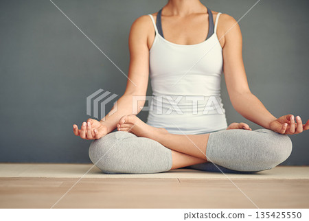 Woman, hands and yoga meditation on floor in spiritual wellness, zen or healthy workout at home. Relax and calm female person or yogi meditating for mindful exercise or awareness on wall mockup space 135425550