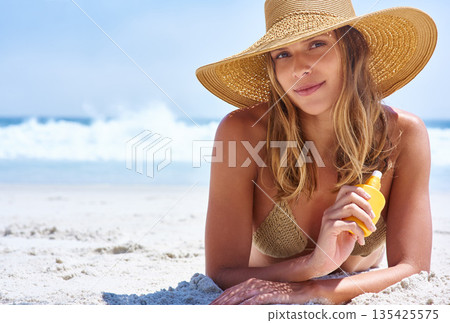 Sunscreen, cream and portrait of woman on beach for skincare, cosmetics and beauty health, summer and holiday. Island, tropical and face of model or young person relax by ocean and dermatology bottle 135425575