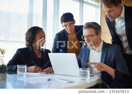 Planning, stock brokers working with laptop and in a boardroom of their workplace. Collaboration or teamwork, brainstorming or finance and coworkers at desk in a modern office discussing a project 135425613