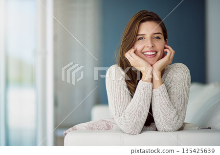 Smile, portrait and woman relax on couch in home living room on holiday. Face, happy and young female person from Canada on sofa in lounge, apartment or house to enjoy me time, vacation or lifestyle. Smile, portrait and woman relax on couch in home living room on holiday. Face, happy and young female person from Canada on sofa in lounge, apartment or house to enjoy me time, vacation or lifestyle. 135425639