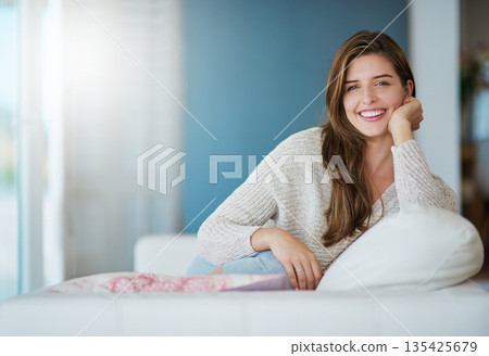 Portrait, happy and woman relax in home living room for easy lifestyle on sofa. Face, smile and young person from Canada on couch in lounge, apartment or house to enjoy me time, break or mockup space Portrait, happy and woman relax in home living room for easy lifestyle on sofa. Face, smile and young person from Canada on couch in lounge, apartment or house to enjoy me time, break or mockup space 135425679