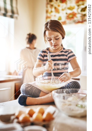 Fun, mixing flour or girl baking in kitchen for cookies pastry or cooking recipe preparation at home. Bowl, playful or young child learning to bake for skills development or independence in a house 135425682