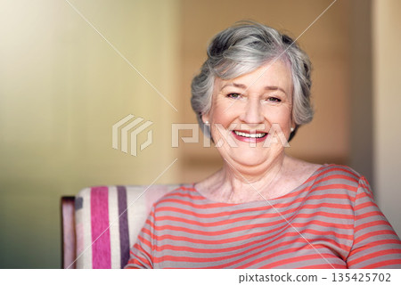 Home, relax and portrait of a senior woman with a smile for retirement and old people happiness. Happy, relaxing and an elderly lady in a chair in the living room with confidence and comfort 135425702