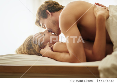 Love, kiss and couple in bed, intimate and romantic with foreplay, loving and bonding together. Sexy, man and woman in a bedroom, passionate and romance with happy relationship, care and hug at home Love, kiss and couple in bed, intimate and romantic with foreplay, loving and bonding together. Sexy, man and woman in a bedroom, passionate and romance with happy relationship, care and hug at home 135425838