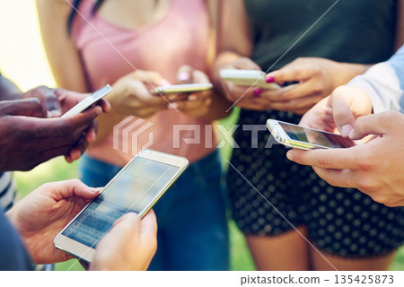 Hands, phone and circle for texting, friends and contact on social media app, web or internet in park. Men, women and smartphone in group for connectivity, online gaming or outdoor in summer together Hands, phone and circle for texting, friends and contact on social media app, web or internet in park. Men, women and smartphone in group for connectivity, online gaming or outdoor in summer together 135425873