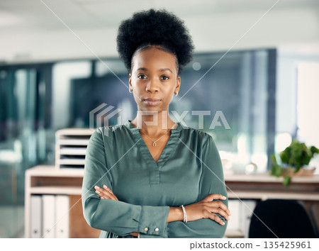 Serious, crossed arms and portrait of a businesswoman in the office with vision, leadership or ideas. Professional, corporate and young African female hr manager standing with pride in the workplace. Serious, crossed arms and portrait of a businesswoman in the office with vision, leadership or ideas. Professional, corporate and young African female hr manager standing with pride in the workplace. 135425961