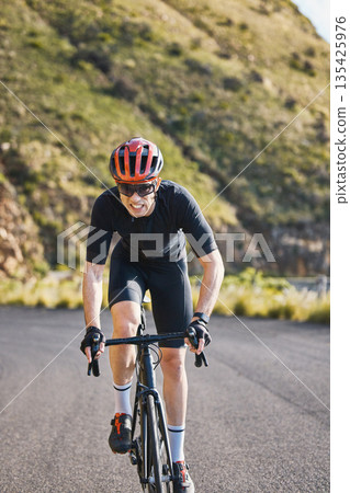 Fitness, bike and cycling with a sports man on a road through the mountain for cardio or endurance. Exercise, workout or training with a male cyclist riding his bicycle on an asphalt street in nature Fitness, bike and cycling with a sports man on a road through the mountain for cardio or endurance. Exercise, workout or training with a male cyclist riding his bicycle on an asphalt street in nature 135425976