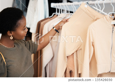Fashion, shopping and choice with black woman in boutique for luxury, sale and retail. Store, product and consumerism with female customer buying in mall for shopaholic, purchase and clothes 135426030