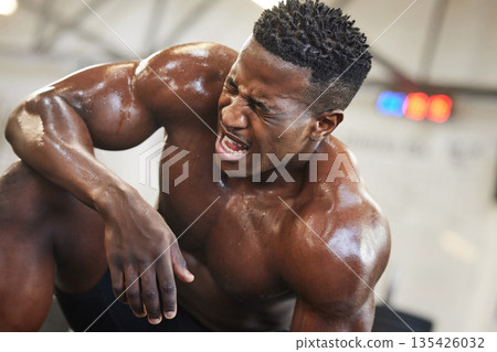 Exercise, muscle and pain with a black man bodybuilder breathing in the gym, exhausted after a workout. Fitness, injury and sweat with a intense, shirtless male athlete taking a break from training Exercise, muscle and pain with a black man bodybuilder breathing in the gym, exhausted after a workout. Fitness, injury and sweat with a intense, shirtless male athlete taking a break from training 135426032