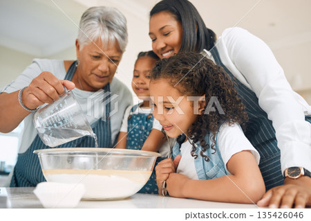 Grandmother, mom or children in kitchen to bake as a happy family with siblings learning cookies recipe. Mixing cake, development or grandma smiling or teaching young kids baking by pouring water Grandmother, mom or children in kitchen to bake as a happy family with siblings learning cookies recipe. Mixing cake, development or grandma smiling or teaching young kids baking by pouring water 135426046